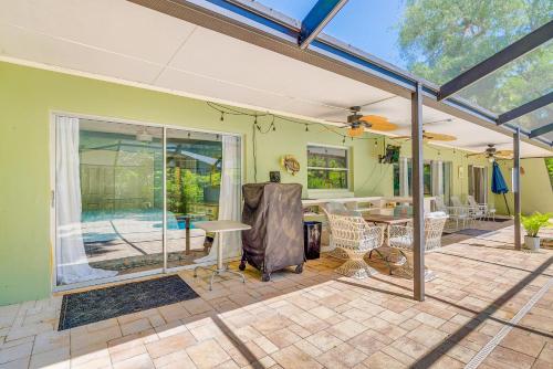 a living room with a patio with a table at Lovely Crystal River Home with Lanai and Pool! in Crystal River