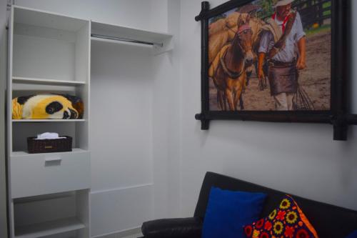 a painting of a man riding a horse on a wall at FILANDIA HOTEL in Filandia