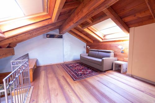 a living room with a couch and a staircase at Hotel Ad Gallias in Bard