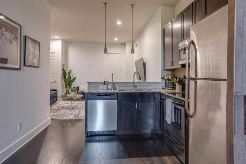 a kitchen with a sink and a refrigerator at Lofts at 30th - 2 Top Floor Units in Nashville