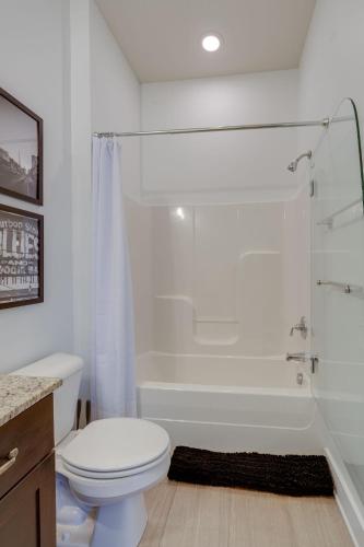 a white bathroom with a toilet and a shower at Lofts at 30th - 2 Top Floor Units in Nashville