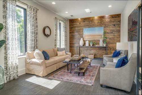 a living room with a couch and a table at Lofts at 30th - 2 Top Floor Units in Nashville