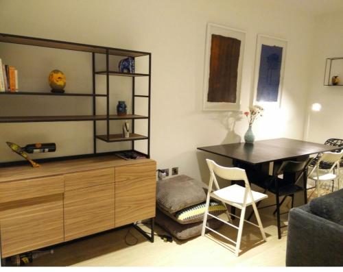a living room with a desk and a table with a chair at Private room in luxury canary wharf apartment in London