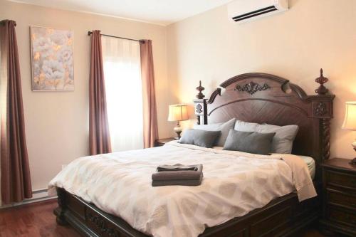 a bedroom with a large bed with a suitcase on it at Walk to South Philly's Best Restaurants & Bars in Philadelphia