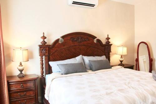 a bedroom with a large wooden bed with two night stands at Walk to South Philly's Best Restaurants & Bars in Philadelphia