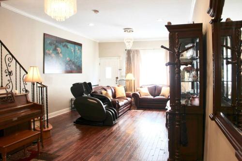 a living room with a couch and a piano at Walk to South Philly's Best Restaurants & Bars in Philadelphia