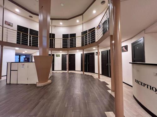 a large room with a lobby with wooden floors at Highland Holiday Home Hostel in Yerevan