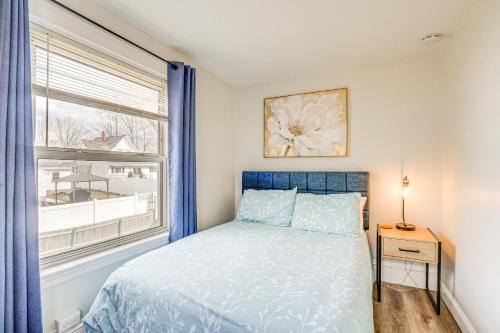a bedroom with a blue bed and a window at Weymouth Apartment Close to Beaches and Boston! in Weymouth
