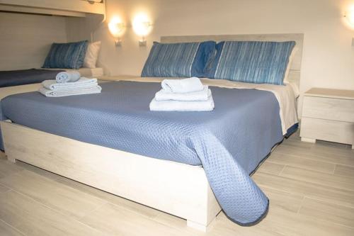 a bedroom with a bed with towels on it at Domus Etruria in Civitavecchia