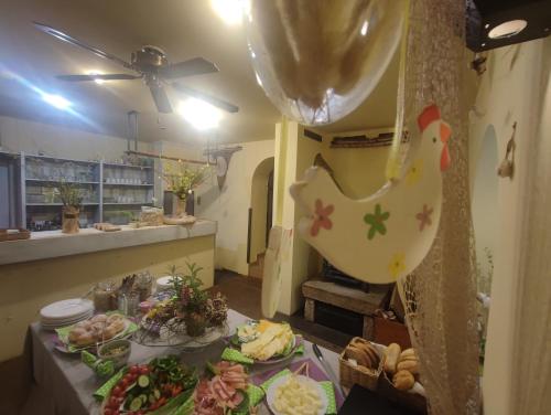a table with plates of food and a chicken on it at Penzion Přívoz in Hřensko