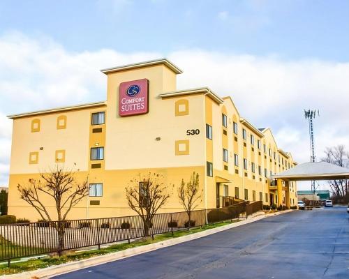 a large yellow building with a sign on it at Comfort Suites Lombard - Addison in Lombard