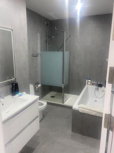a bathroom with a shower and a toilet and a sink at 2 Bed Apartment in Gibraltar - Marina Views in Gibraltar