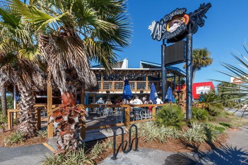a restaurant with palm trees in front of a resort at Pirates Bay B303 in Fort Walton Beach