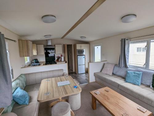 a living room with a couch and a table at D11 - the Dunes at Silver Sands in Lossiemouth