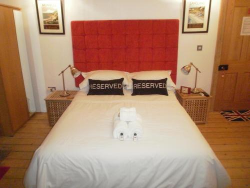 a bedroom with a bed with two towels on it at Langland Road B&B in The Mumbles