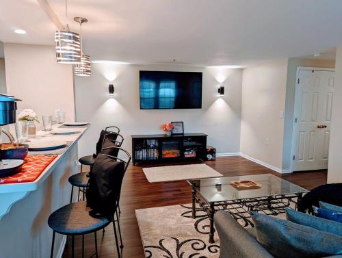 a kitchen and living room with a counter and a table at Lovely Luxury Condo in Glen Allen