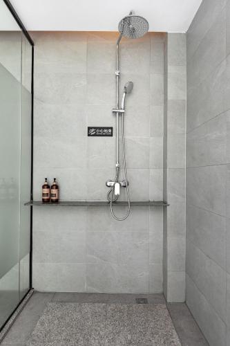 a shower with a shower head in a bathroom at Avatar Mountain Resort in Zhangjiajie