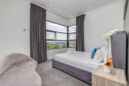 a bedroom with a bed and a large window at Luxurious & Peaceful Sandton 3-bed - Backup Power in Johannesburg