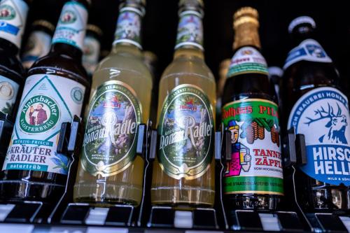 a display of beer bottles on a store shelf at Höhengasthaus Kolmenhof an der Donauquelle in Furtwangen