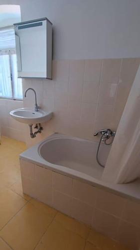 a bathroom with a bath tub and a sink at Altana Rooms Apartment in Koper