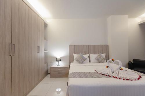 Ένα ή περισσότερα κρεβάτια σε δωμάτιο στο SUBANAN Residence Hatyai - ทรัพย์อนันต์ เรสซิเด้นซ์ หาดใหญ่