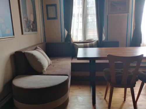a living room with a couch and a table at Къща за гости Георги Божилов - Слона in Plovdiv