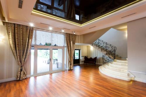 a living room with a staircase and a stair case at Hotel Panorama in Ostrowiec Świętokrzyski