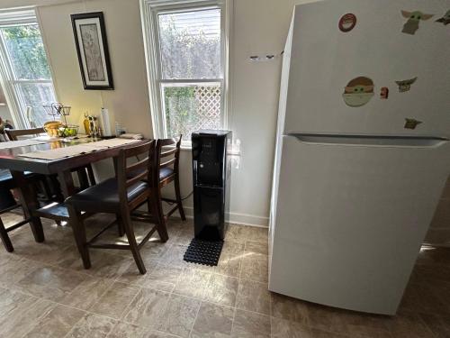 a kitchen with a white refrigerator and a table at 5 Minutes walk to VCU in Richmond