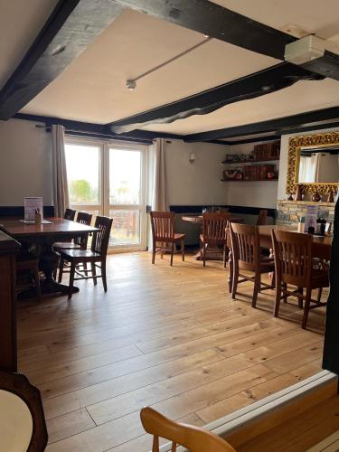 a dining room with wooden tables and chairs at The Malt Shovel Inn in Bridgwater