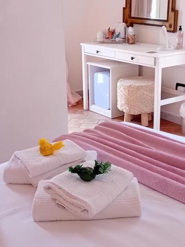 two towels on a bed in a room with a sink at Raggio di Luna in Manarola