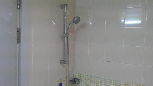 a shower with a shower head in a bathroom at Ruby Star Studio Apratment in Dubai