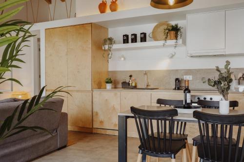 a kitchen with a table and chairs and a couch at Relaxing House Faro - Rogil 4 in Aljezur