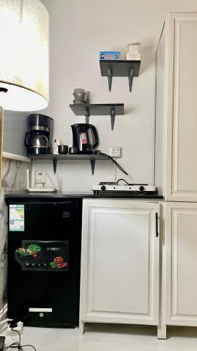 a kitchen with a black dishwasher in a kitchen at Smart Entry Apartment in Riyadh