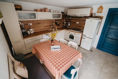 a small kitchen with a table and a refrigerator at DREVENICA in Hrabušice