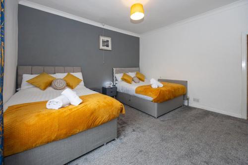 a bedroom with two beds with towels on them at Cosy Two bedroom Terrace Blackburn in Cherry Tree