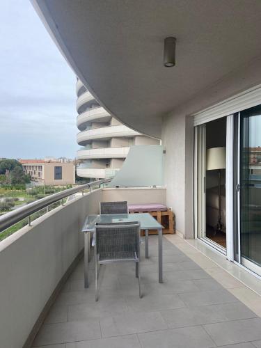 a balcony with a table and chairs on a building at Casa del Porto in Pesaro