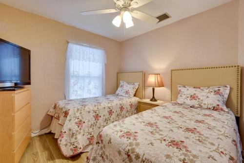 a bedroom with two beds and a flat screen tv at 10 Mi to Coquina Beach Spacious Bradenton Duplex in Bradenton