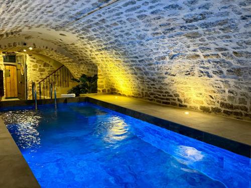 uma piscina num edifício com água azul em Les Suites de l'Enclos - L'Enclos de l'Evêché em Boulogne-sur-Mer