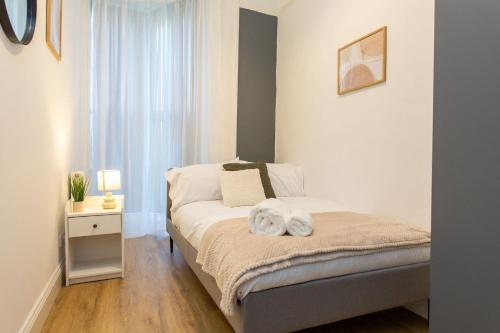 1 dormitorio con 1 cama con 2 toallas en Free Parking | Free Wifi | Smart TV en Sketty