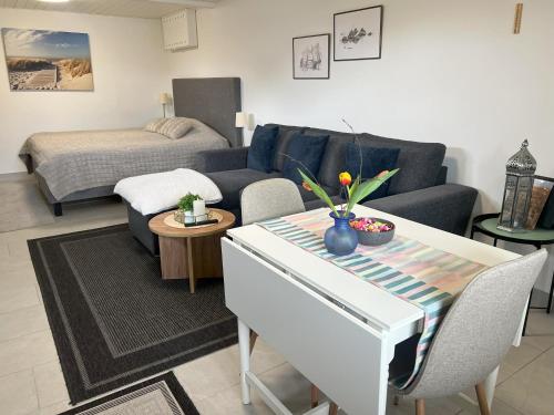 - un salon avec un canapé et un lit dans l'établissement Vik Österlen, à Simrishamn
