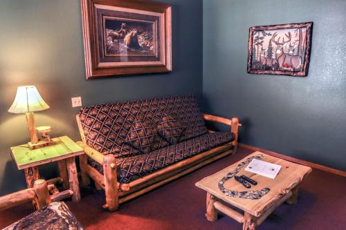 a living room with a couch and a table at Timber Creek Chalets- 6 chalet in Estes Park