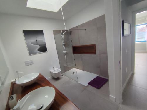 a bathroom with a shower and a toilet and a sink at Casa Manrique in Famara