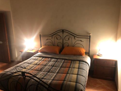 een bed met 2 oranje kussens in een slaapkamer bij Casa Vittoria in Portici