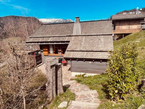 a large house with a stone walkway in front of it at LA GODILLE in La Clusaz