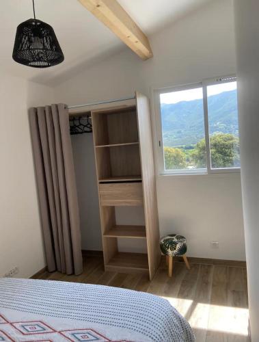 une chambre avec un lit et une fenêtre dans l'établissement Villa Sampiero, à Sarrola-Carcopino