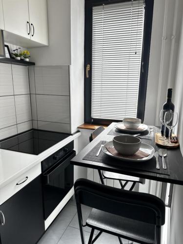 a kitchen with a table with two bowls on it at Studio apartman Lynx in Plitvička Jezera