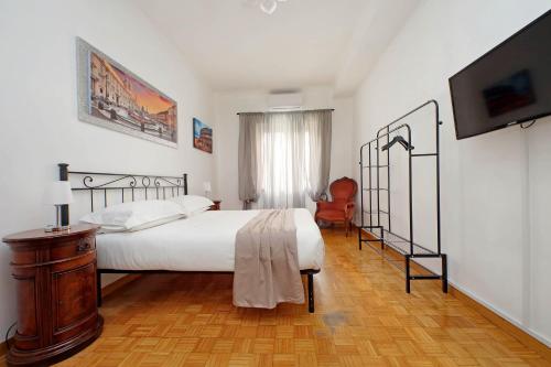 a bedroom with a bed and a flat screen tv at Pigneto Cozy Flat in Rome