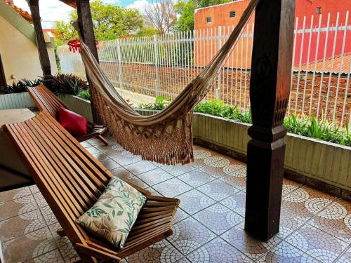 a patio with two hammocks and a table and a table at Hotel Palermo in Santa Cruz de la Sierra
