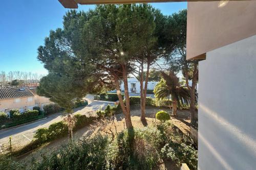 une vue aérienne sur une rue arborée et un bâtiment dans l'établissement Triangle de la Baronnie Appartement 1 chambre proche de la Mer, au Grau-du-Roi