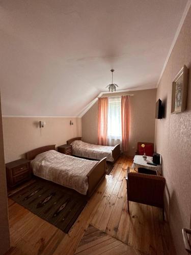 a hotel room with two beds and a window at Роксолана in Truskavets